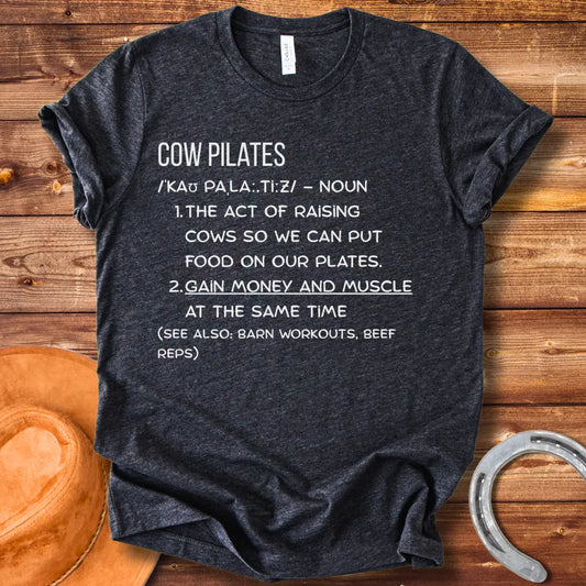 A stylish black t-shirt design featuring a cow doing pilates, against a black background.