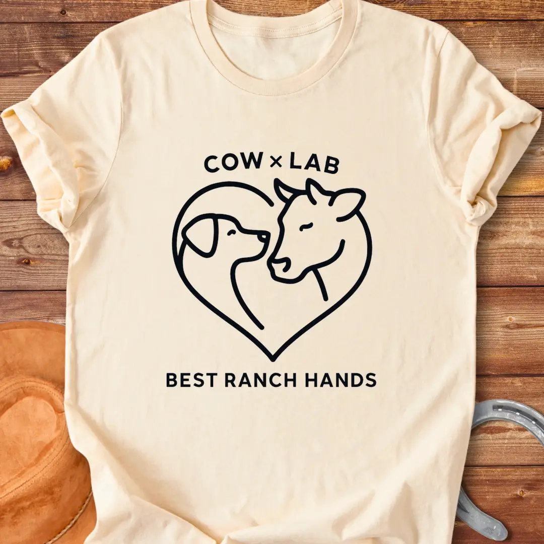 Cow x Lab T-Shirt design featuring a cow and a dog embracing within a heart shape, with the words 'Best Ranch Hands' at the bottom.
