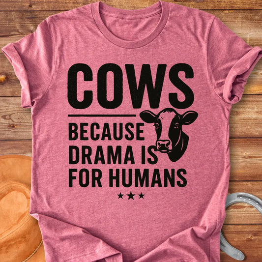 Black t-shirt design with the words 'Cows because drama is for humans' and a cow head illustration.