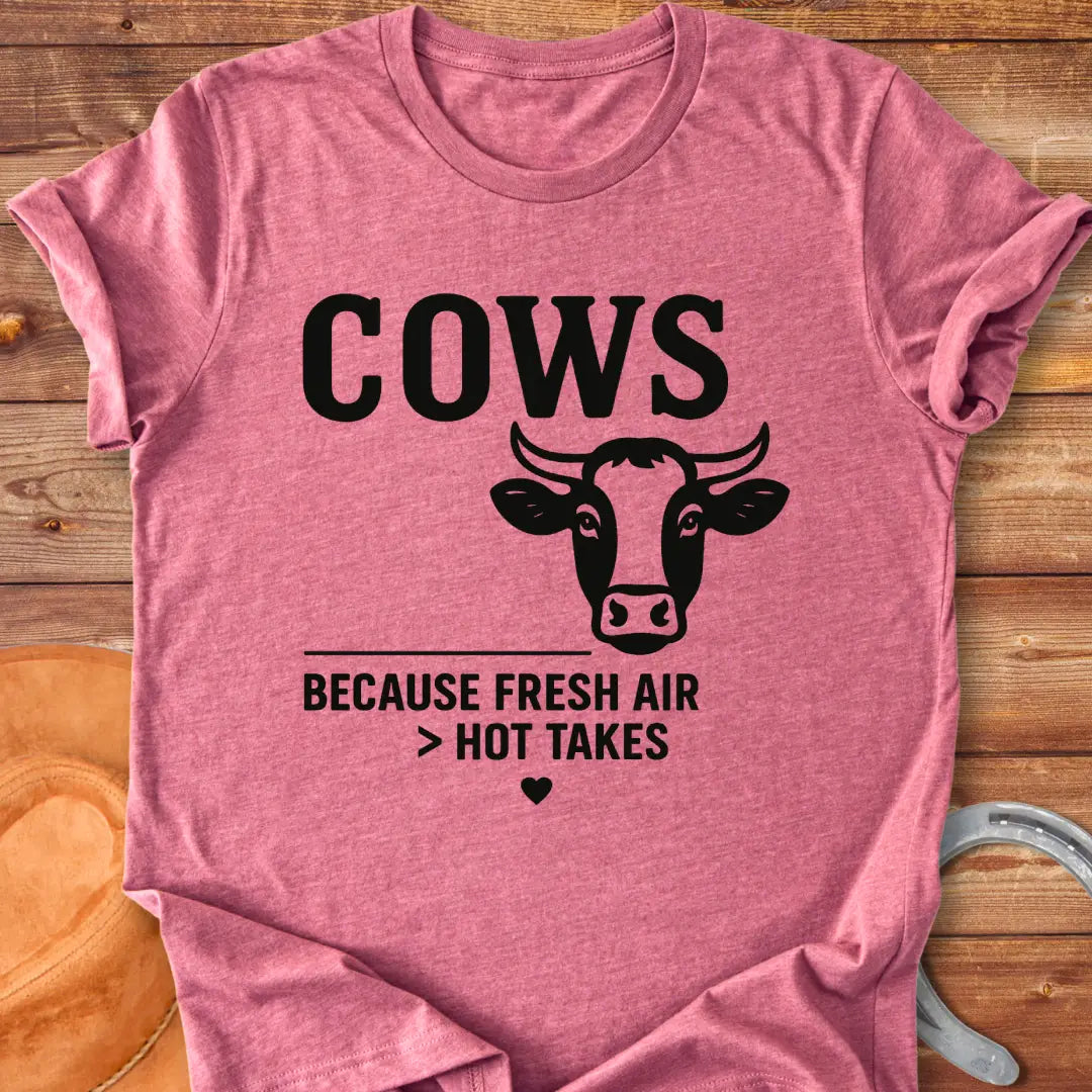 Black and white t-shirt with a cow graphic and the text 'Cows Because Fresh Air Better Than Hot Takes.'