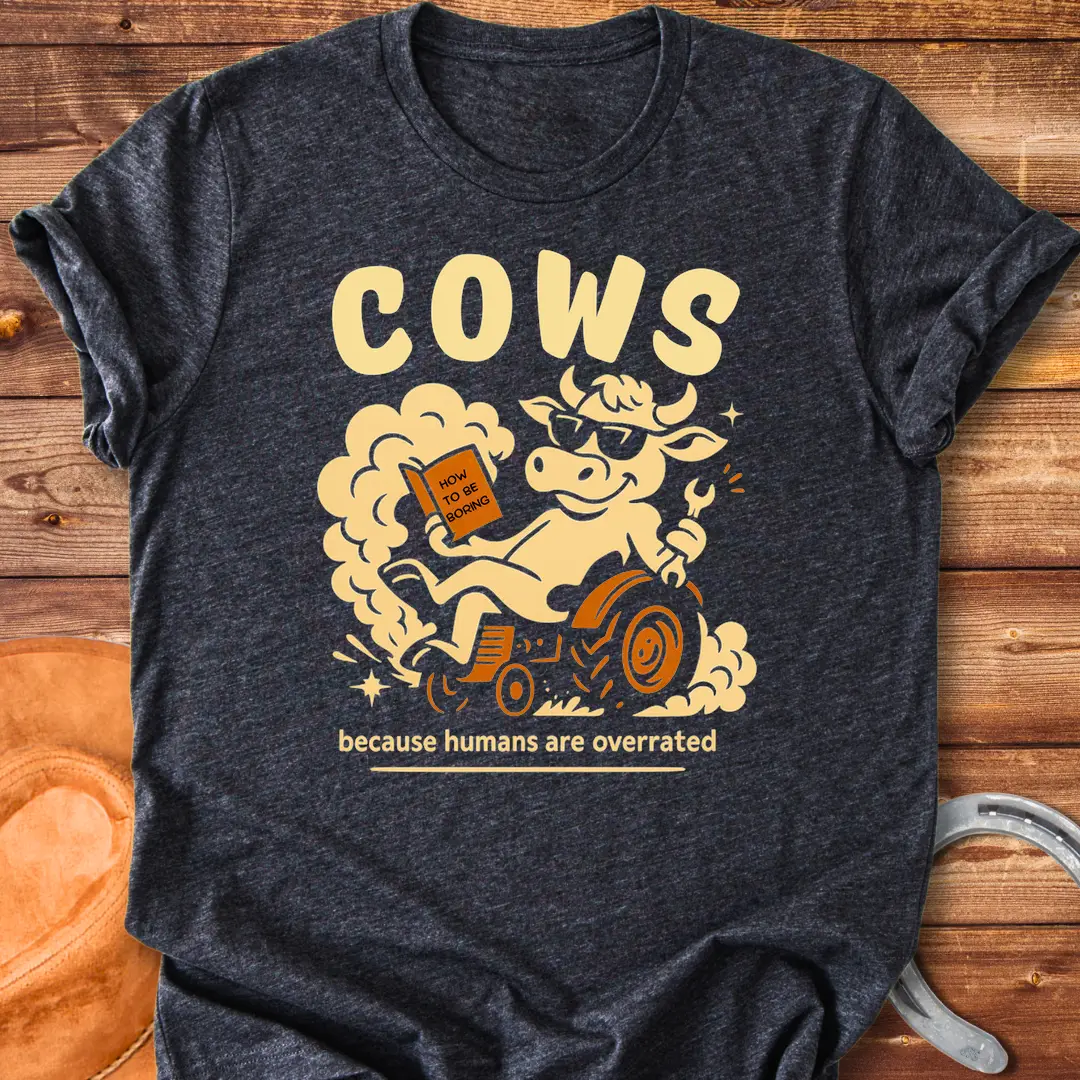 Funny t-shirt design featuring a cool cow reading a book on a tractor with the phrase 'Cows Because Humans Overrated'