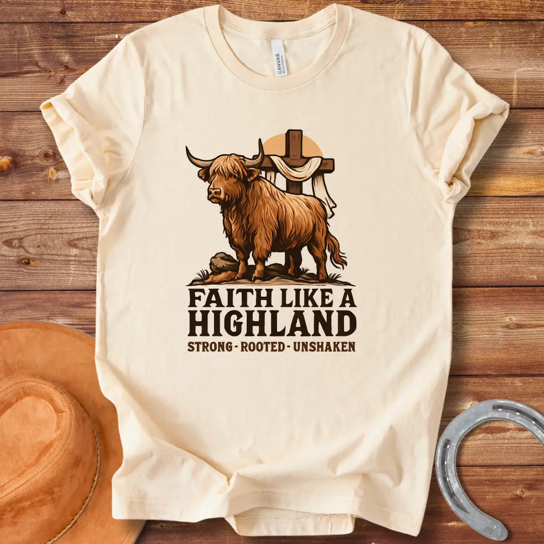 Highland cow t-shirt design with a cross and the words Faith Like A Highland. A brown cow stands in front of a cross.