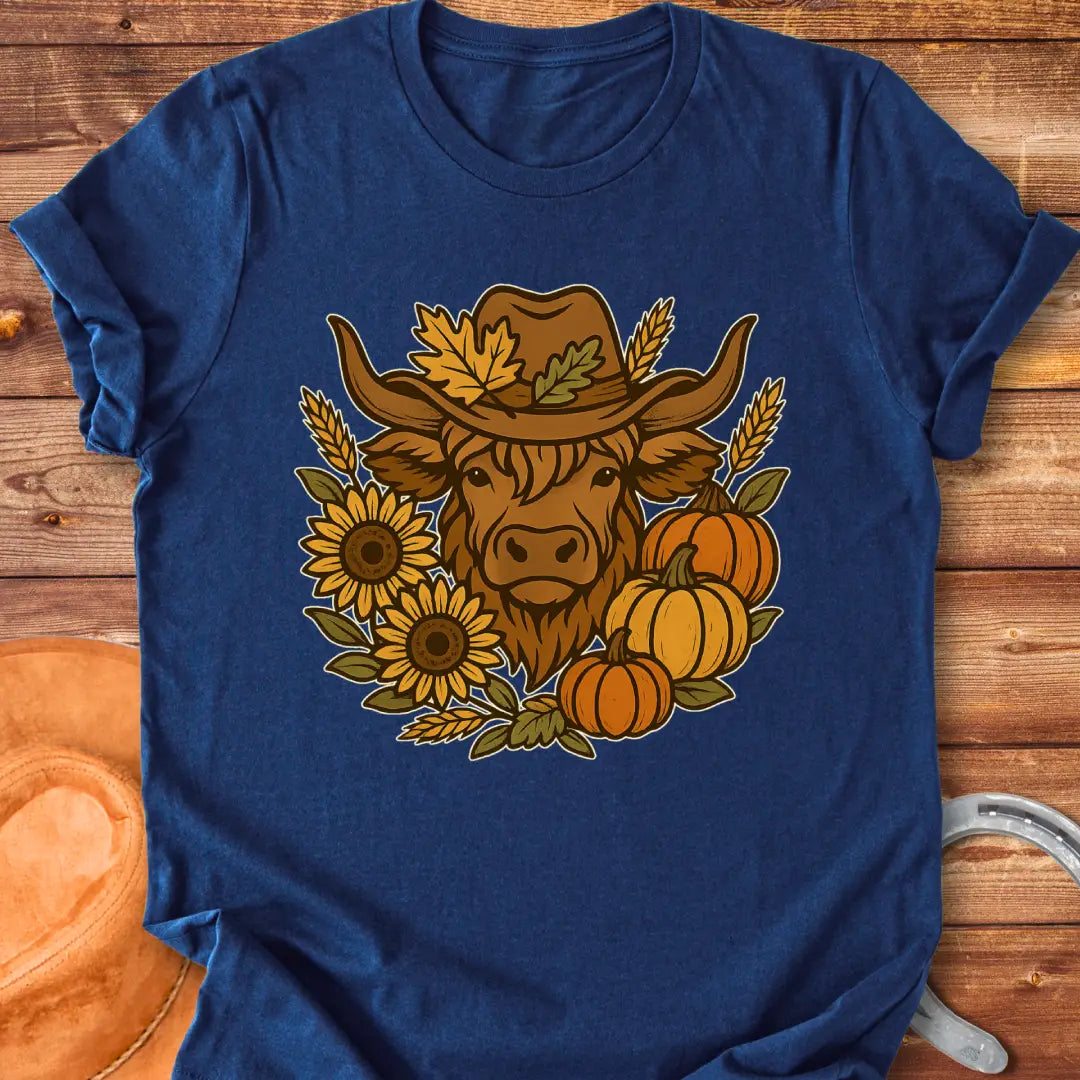 Farmhouse Fall T-Shirt featuring a Highland cow wearing a hat surrounded by sunflowers, pumpkins, and leaves