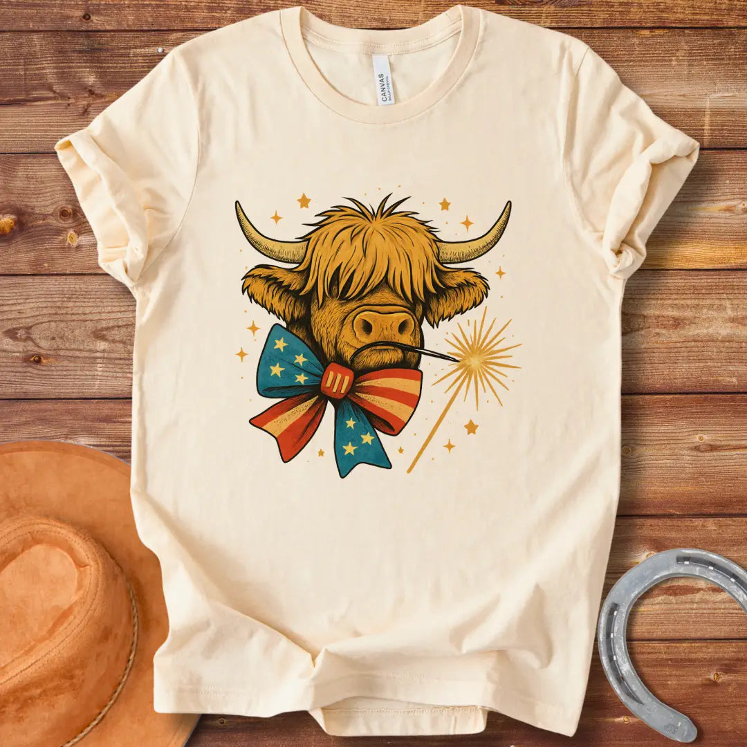 Festive patriotic Highland cow wearing a patriotic bow tie holding a sparkler.