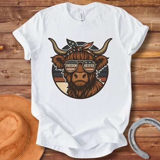 Freedom Heifer T-Shirt: Highland cow wearing sunglasses with the American flag design.