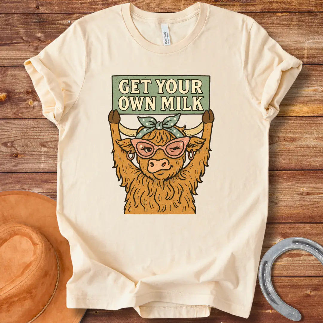 A sassy highland cow wearing sunglasses, holding a sign that reads 'Get Your Own Milk'