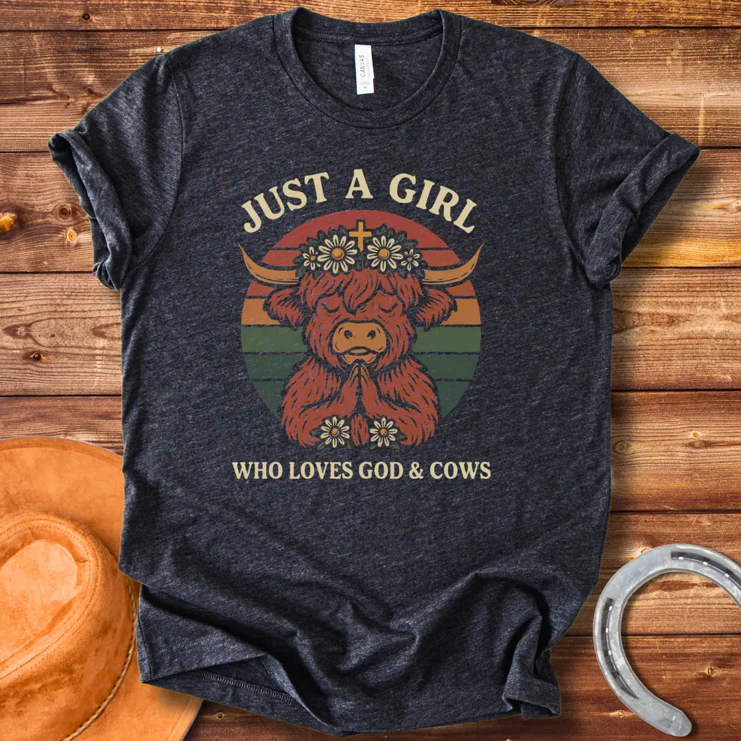 A praying Highland cow wearing a daisy crown with a cross, set against a retro sunset graphic. Text reads: 'Just a girl who loves God & Cows'.