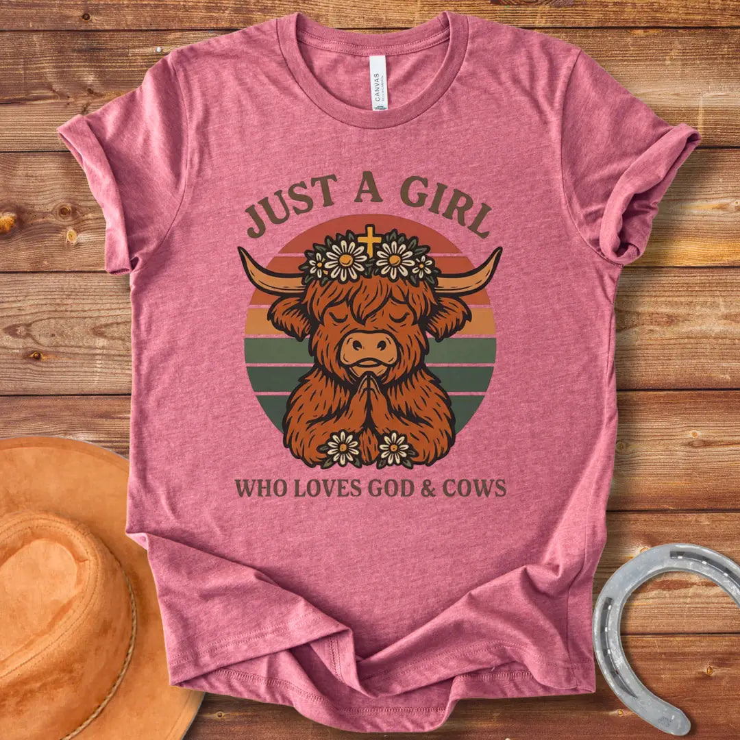 A praying Highland cow wearing a daisy crown with a cross, set against a retro sunset graphic. Text reads: 'Just a girl who loves God & Cows'.