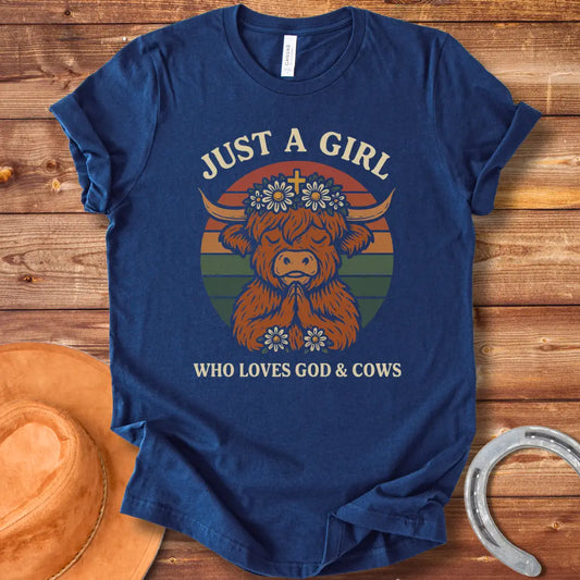 A praying Highland cow wearing a daisy crown with a cross, set against a retro sunset graphic. Text reads: 'Just a girl who loves God & Cows'.