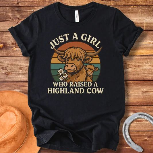 T-shirt design featuring a Highland cow with her calf, the words 'Just a girl who raised a highland cow', and daisies on a vintage sunset background.