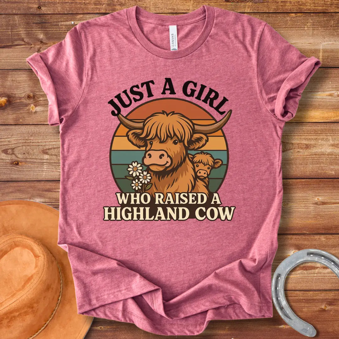 T-shirt design featuring a Highland cow with her calf, the words 'Just a girl who raised a highland cow', and daisies on a vintage sunset background.