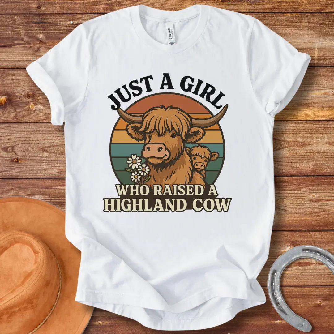 T-shirt design featuring a Highland cow with her calf, the words 'Just a girl who raised a highland cow', and daisies on a vintage sunset background.