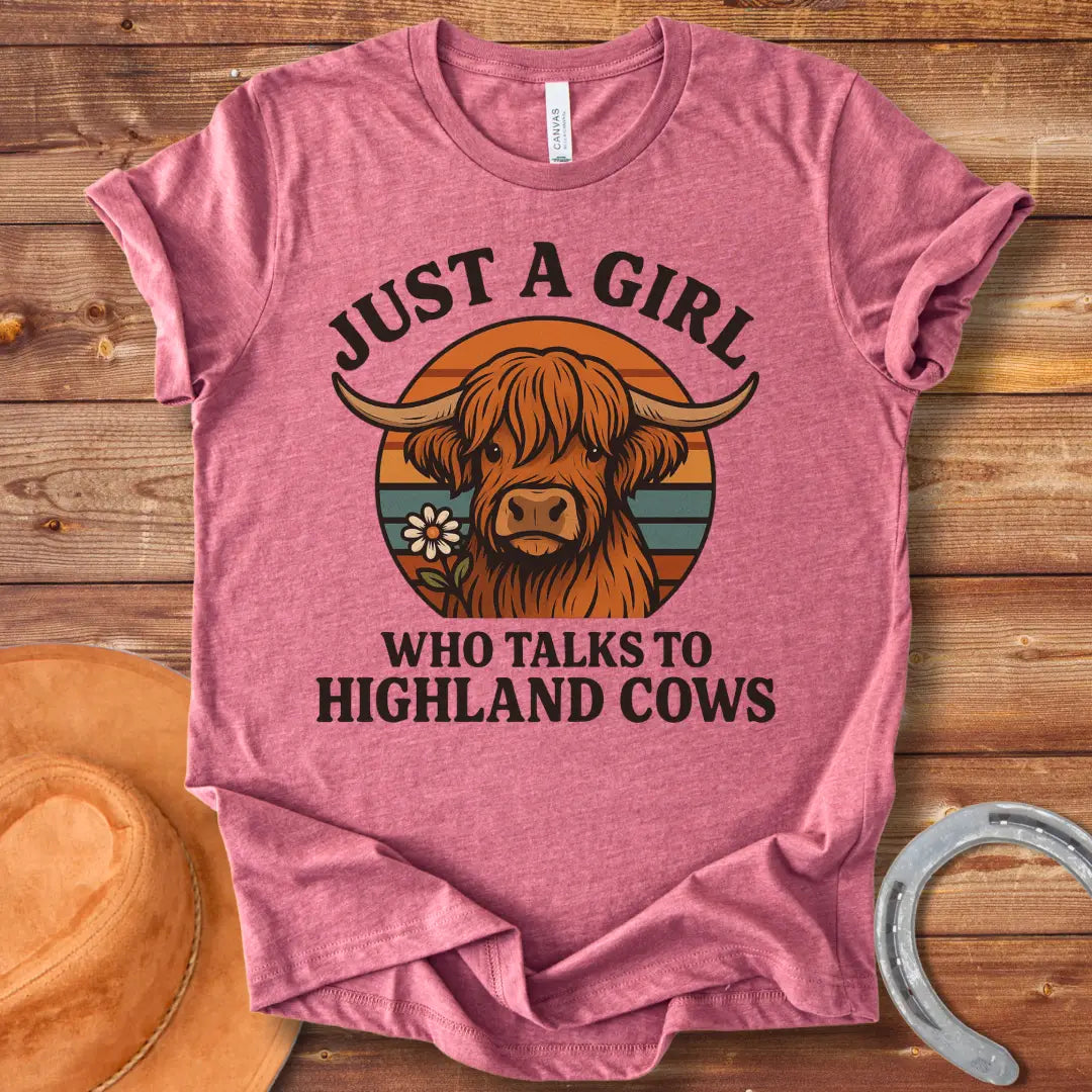 T-shirt featuring a cute Highland cow graphic with the text 'Just a Girl Who Talks to Highland Cows' and a flower.