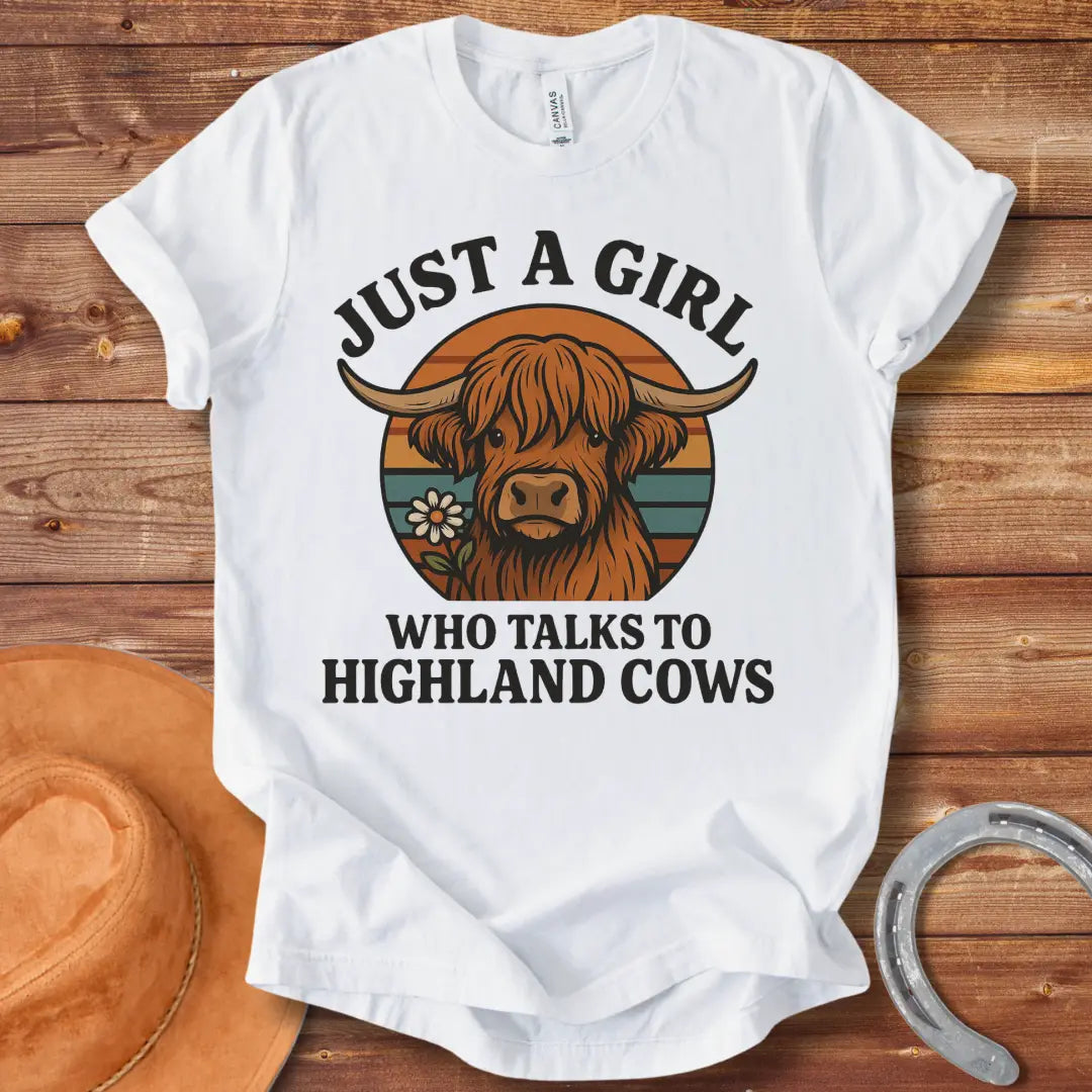 T-shirt featuring a cute Highland cow graphic with the text 'Just a Girl Who Talks to Highland Cows' and a flower.