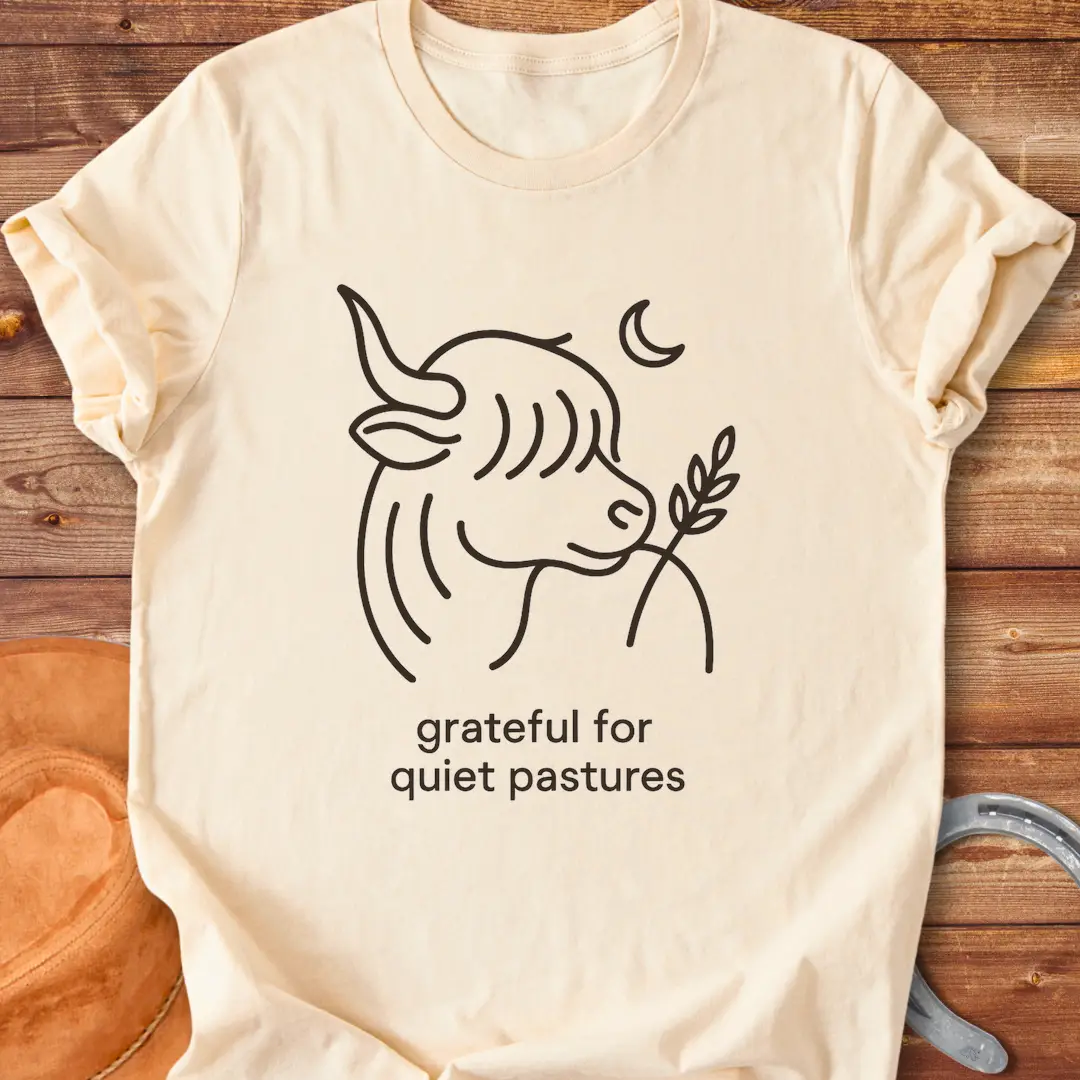 Line art of a Highland cow enjoying a sprig of grass, with the words 'grateful for quiet pastures'