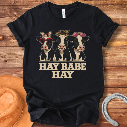 Hay Babe Hay T-Shirt featuring three stylish cows wearing sunglasses and bandanas. Text reads 'Hay Babe Hay'.