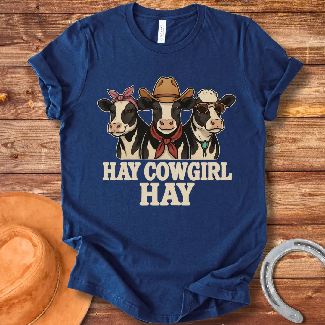 Three cartoon cows, one with a bandana, one with a cowboy hat and scarf, and one with sunglasses, with the text 'Hay Cow Girl Hay' below.