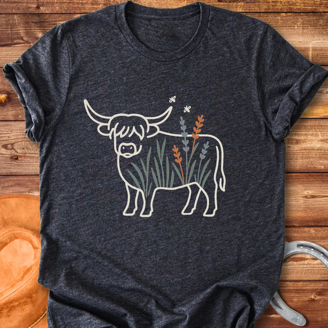 Line drawing of a Highland cow with floral accents on a black background.