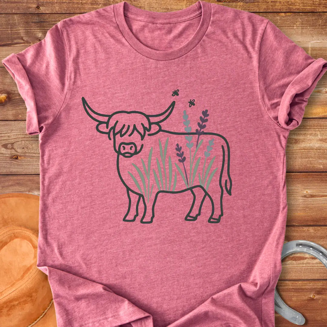 Line drawing of a Highland cow with floral accents on a black background.