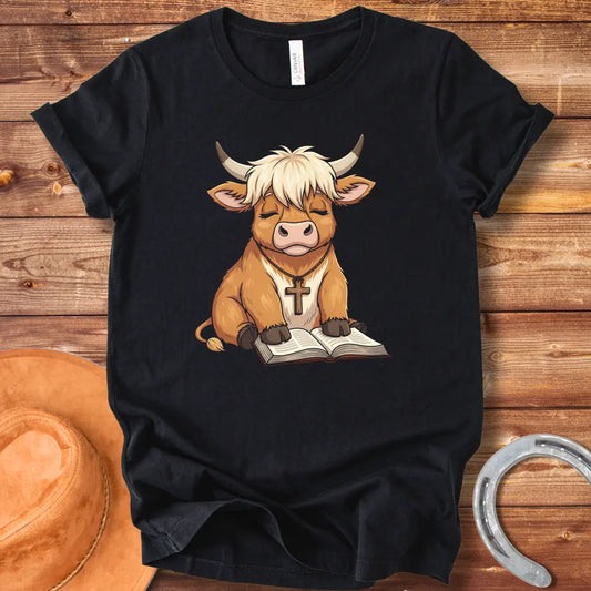 Cartoon illustration of a cow wearing a cross necklace, sitting peacefully with a book open in its lap.