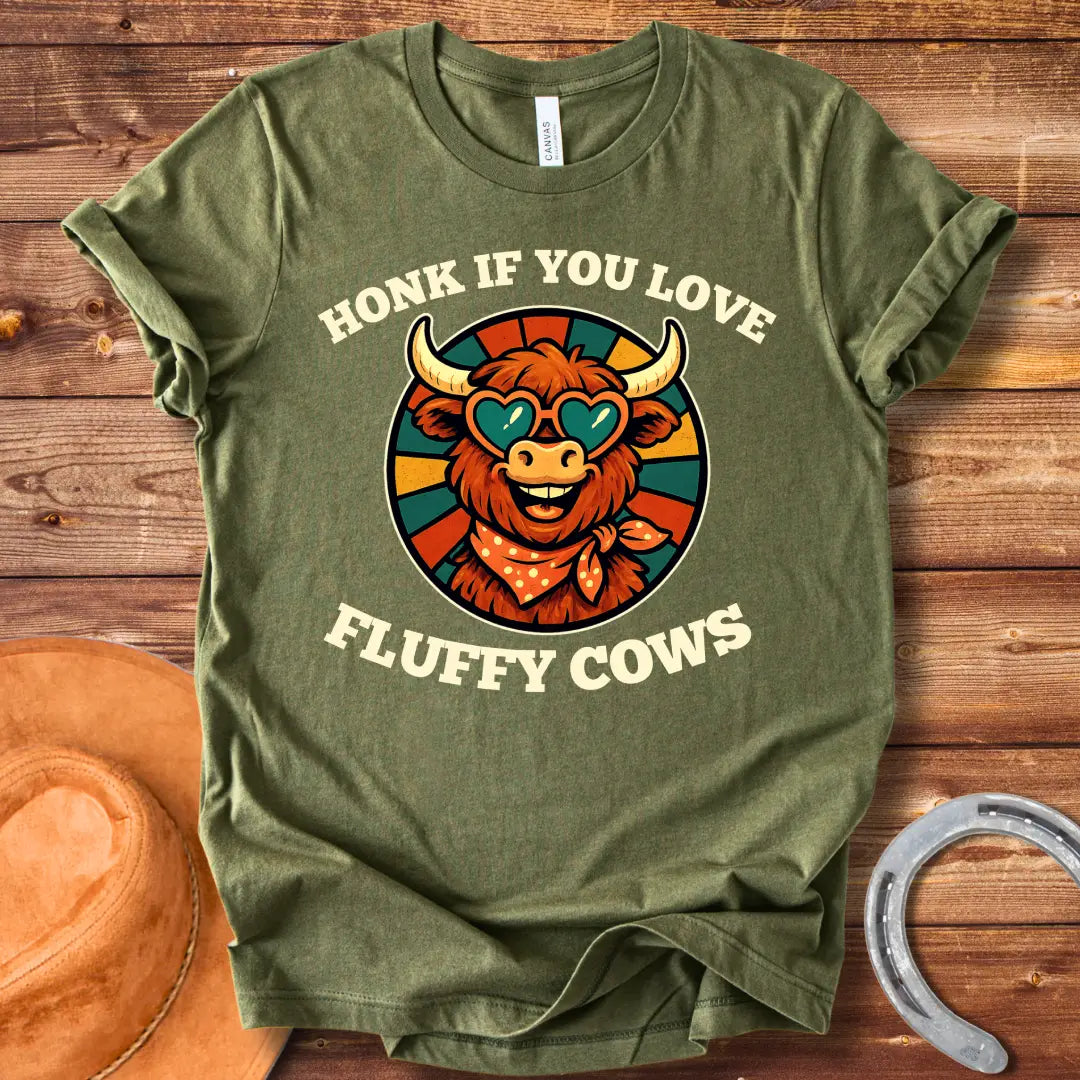 T-shirt design with a smiling cow wearing heart-shaped sunglasses and a bandana, with the text 'Honk If You Love Fluffy Cows'.