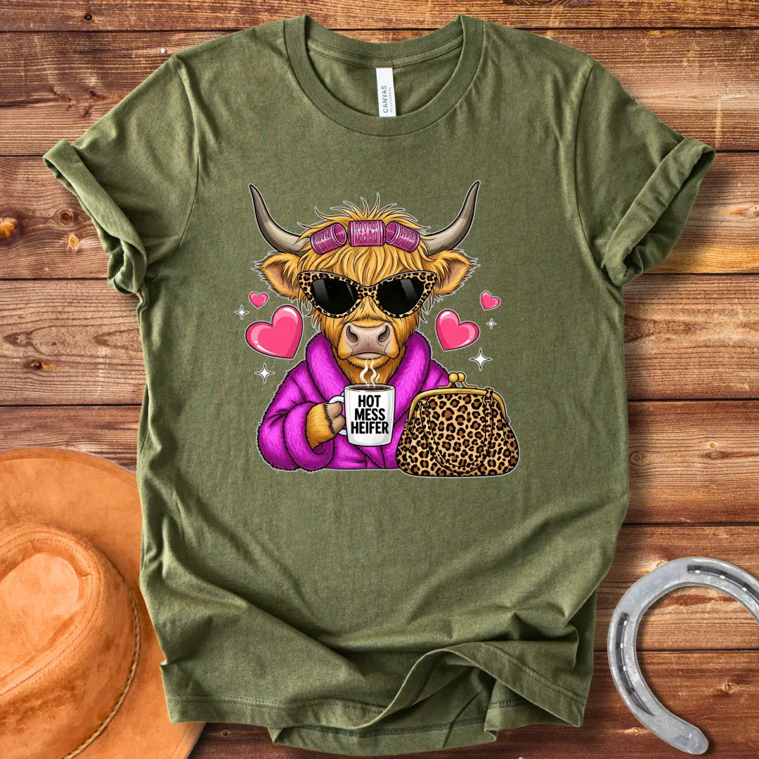 Cartoon image of a cow wearing sunglasses and a robe, holding a mug that says 'Hot Mess Heifer', with a leopard print purse and heart illustrations. 