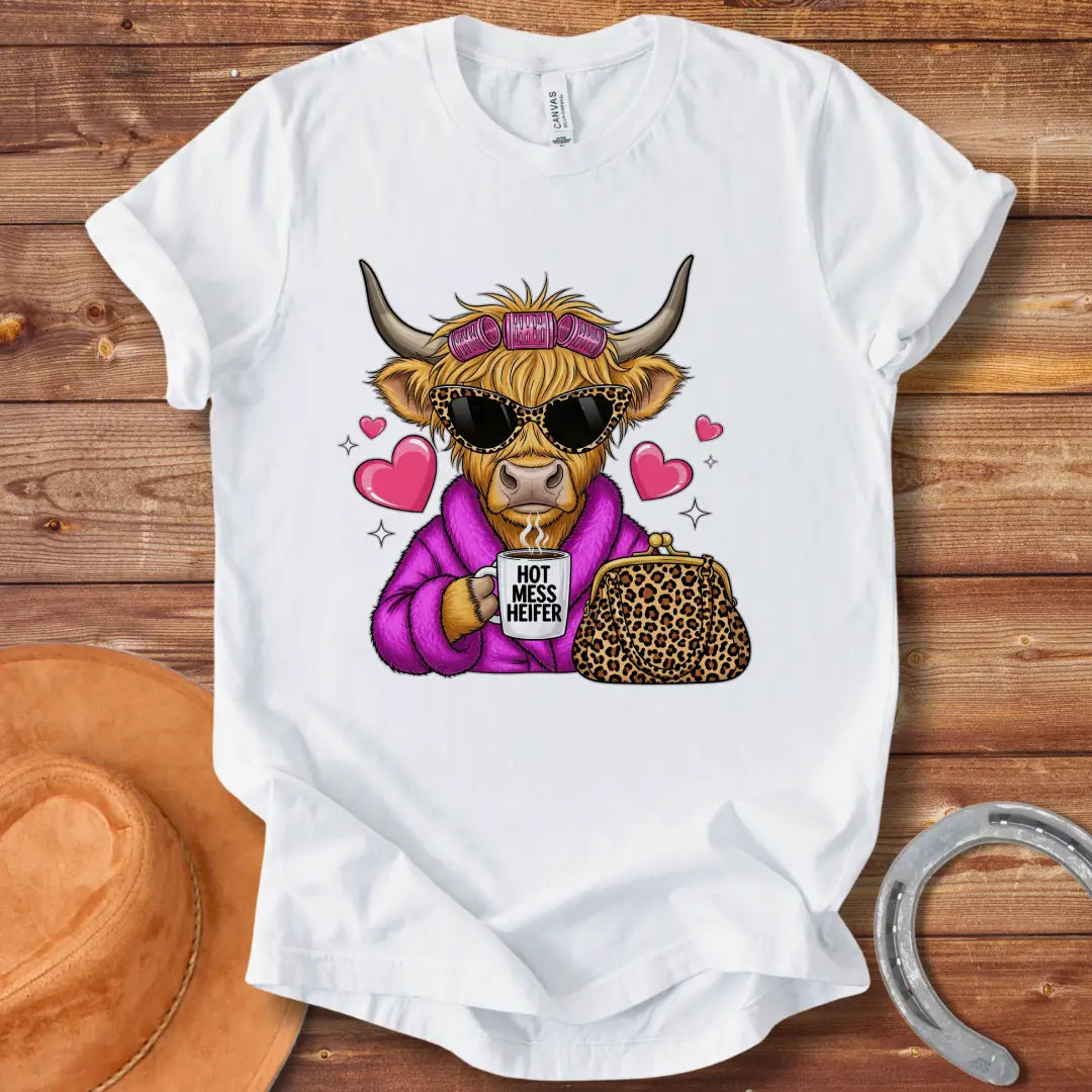 Cartoon image of a cow wearing sunglasses and a robe, holding a mug that says 'Hot Mess Heifer', with a leopard print purse and heart illustrations. 
