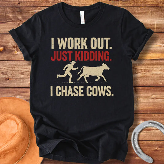 Vintage T-shirt with a humorous design of a person chasing a cow, with the words 'I Work Out. Just Kidding. I Chase Cows.'