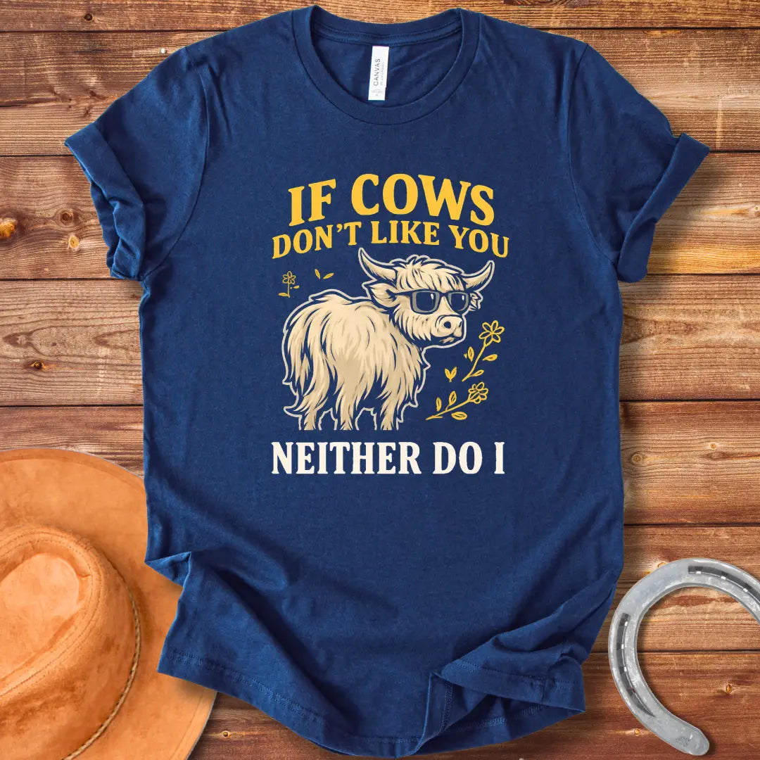 T-shirt design featuring a cool cow wearing sunglasses with the text 'If Cows Don't Like You Neither Do I' in brown and blue font on a black background.