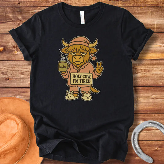Illustration of a tired cow in pajamas holding a coffee mug that says 'Cowfee,' holding up a peace sign, and wearing bunny slippers. Text on the cow's sign reads 'Holy Cow, I'm Tired.'