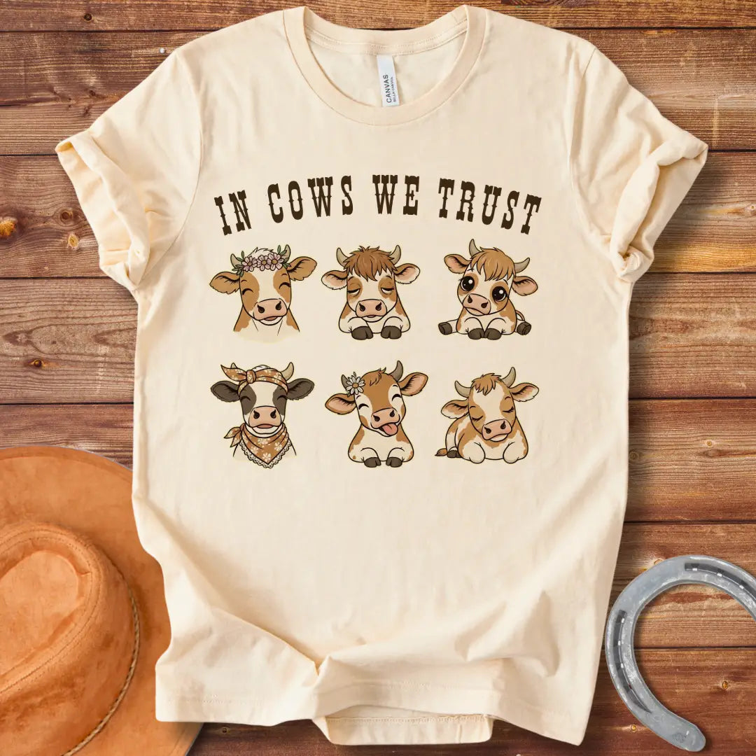 In Cows We Trust t-shirt featuring an illustration of six cute cows with different personalities.