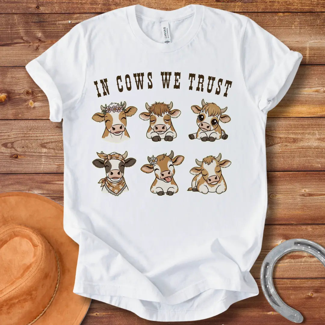 In Cows We Trust t-shirt featuring an illustration of six cute cows with different personalities.