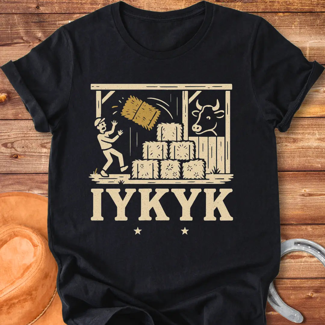 Funny t-shirt design featuring a person surprised by falling hay with a cow watching in the background.