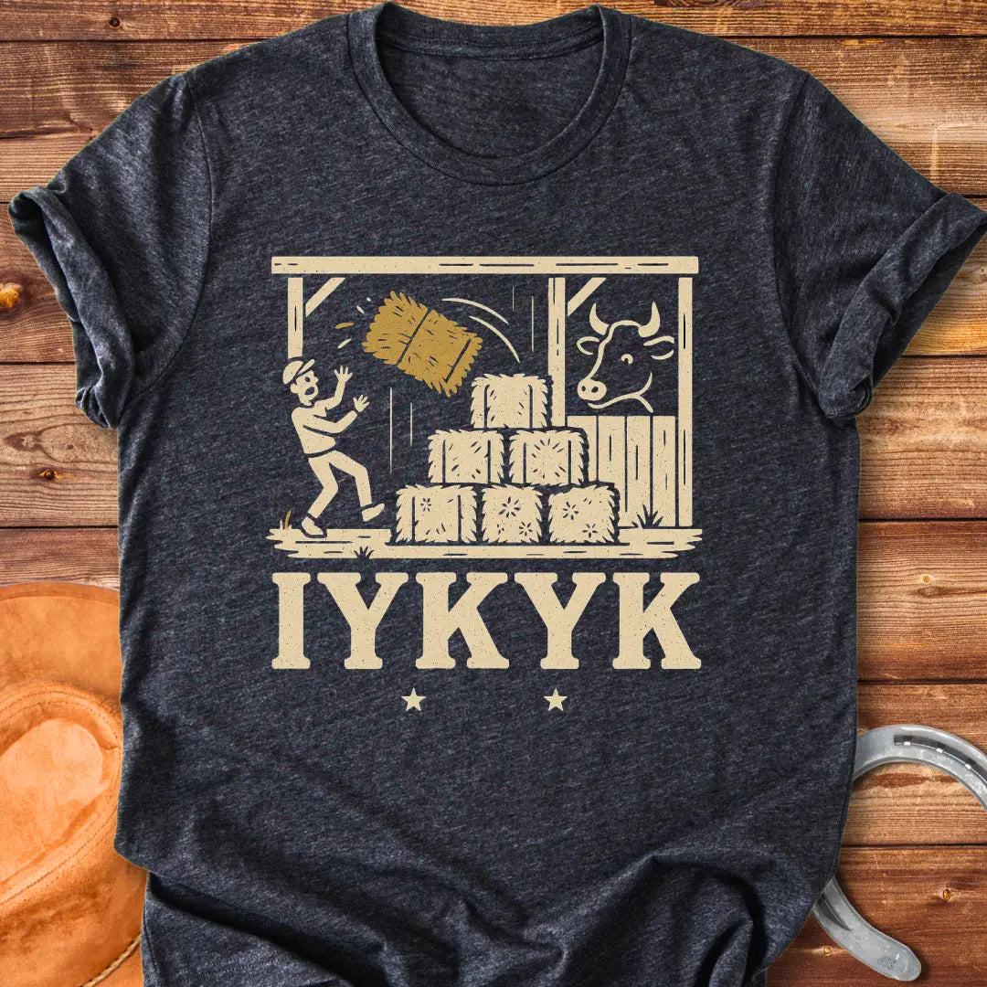 Funny t-shirt design featuring a person surprised by falling hay with a cow watching in the background.