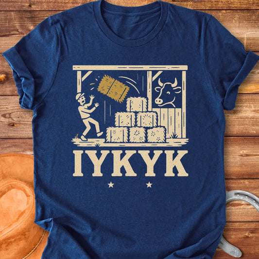 Funny t-shirt design featuring a person surprised by falling hay with a cow watching in the background.