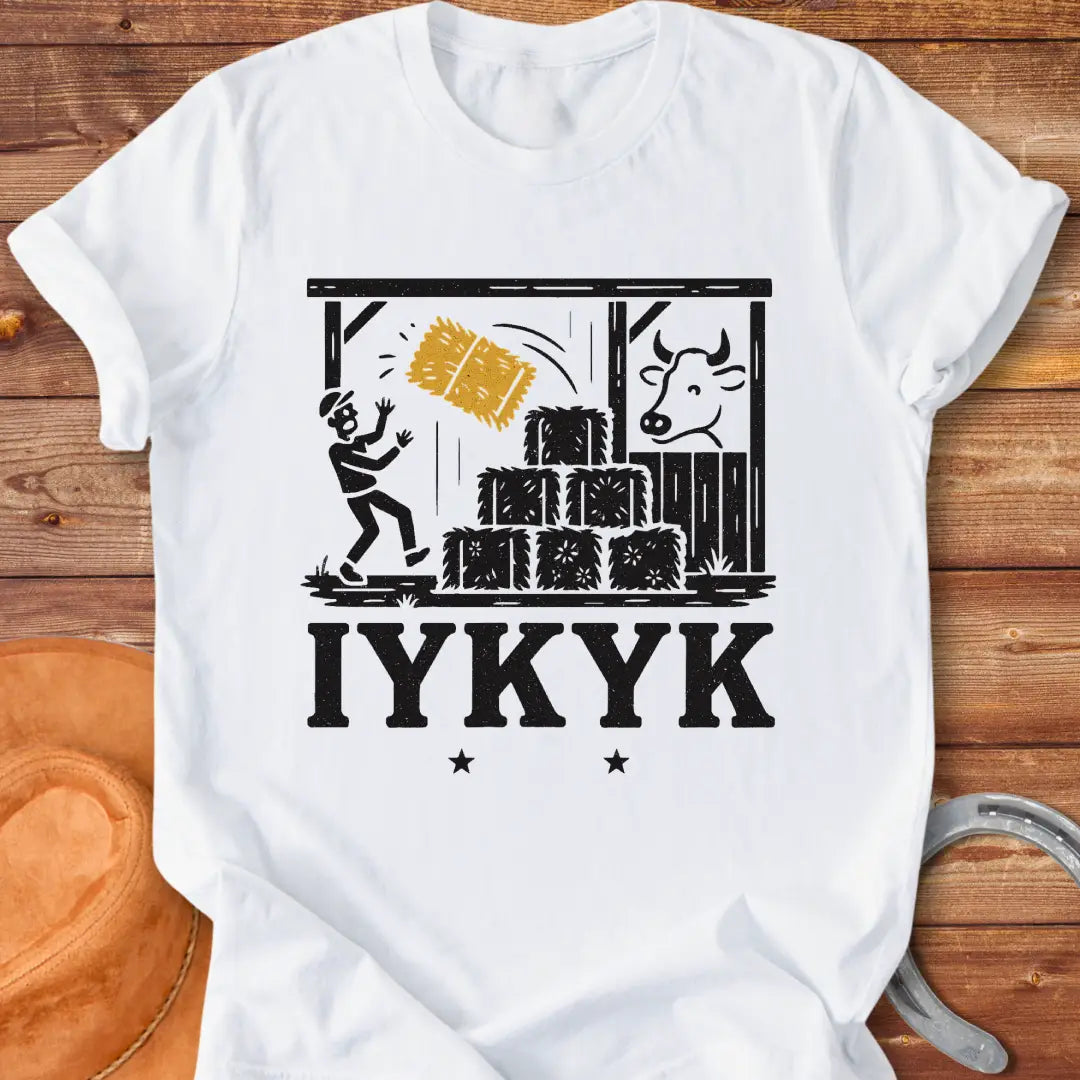 Funny t-shirt design featuring a person surprised by falling hay with a cow watching in the background.