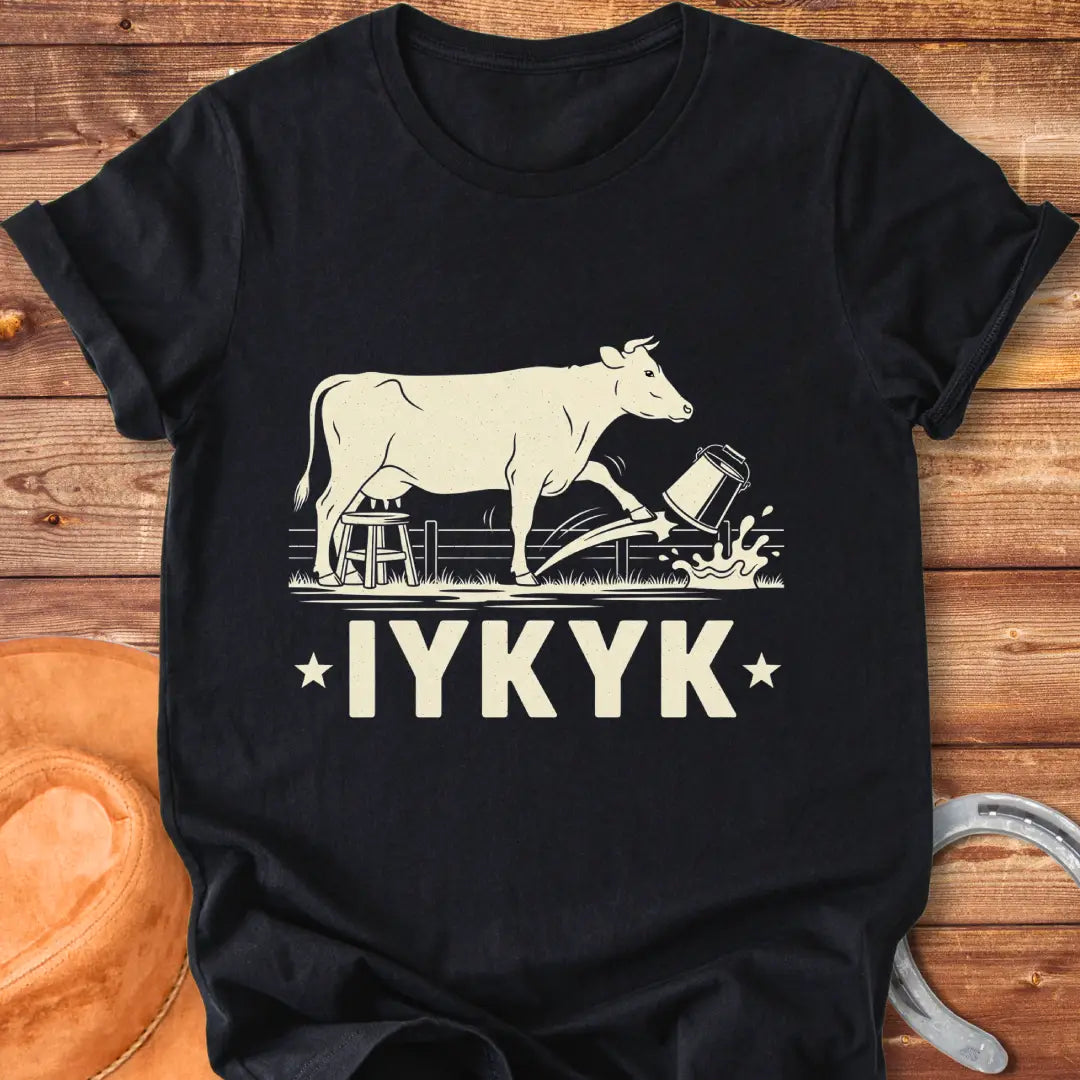 Illustration of a cow kicking a bucket, with the words 'IYKYK' and a farm scene background.