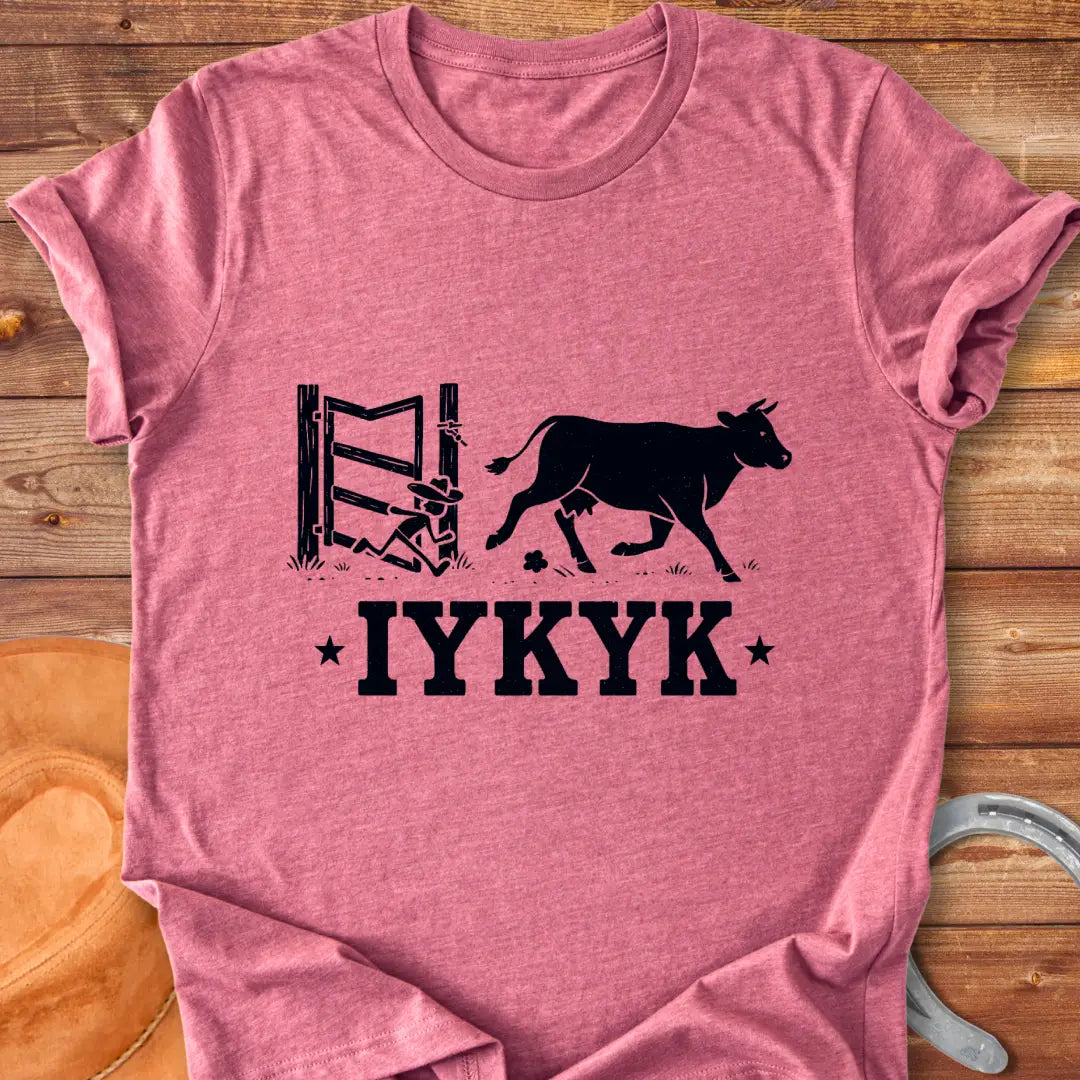 Silhouette of a cow running through an open gate with IYKYK text below.