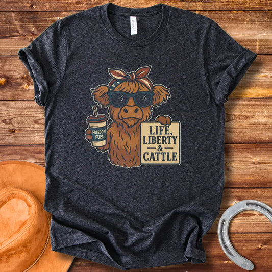 A Highland cow wearing sunglasses and a bandana, holding a sign that says 'Life, Liberty & Cattle' and a cup that says 'Freedom Fuel'.