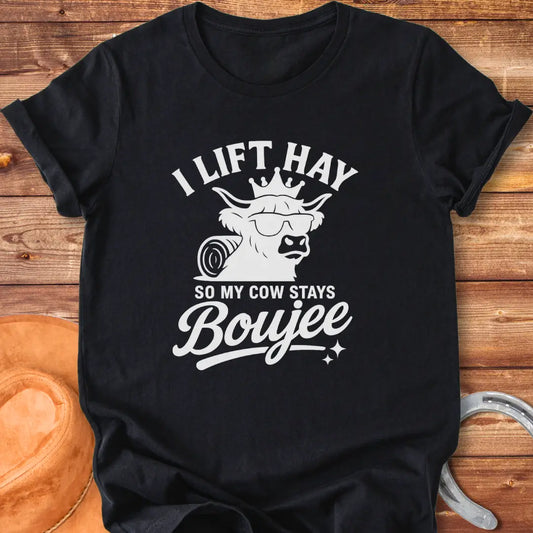 A Highland cow wearing sunglasses and a crown, the text saying 'I lift hay so my cow stays boujee'