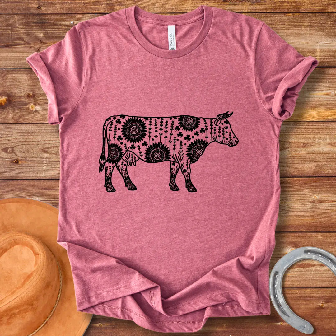 Mandala floral cow design on a t-shirt. The design features a cow silhouette filled with intricate floral patterns.