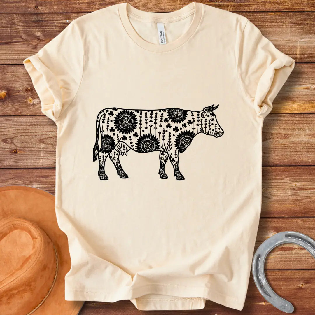 Mandala floral cow design on a t-shirt. The design features a cow silhouette filled with intricate floral patterns.