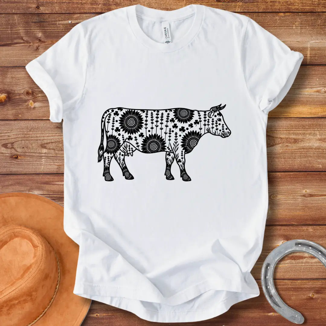 Mandala floral cow design on a t-shirt. The design features a cow silhouette filled with intricate floral patterns.