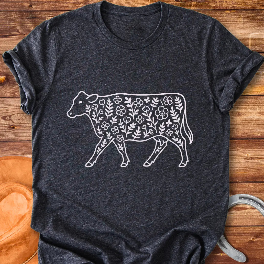 Black and white illustration of a cow with floral design inside.
