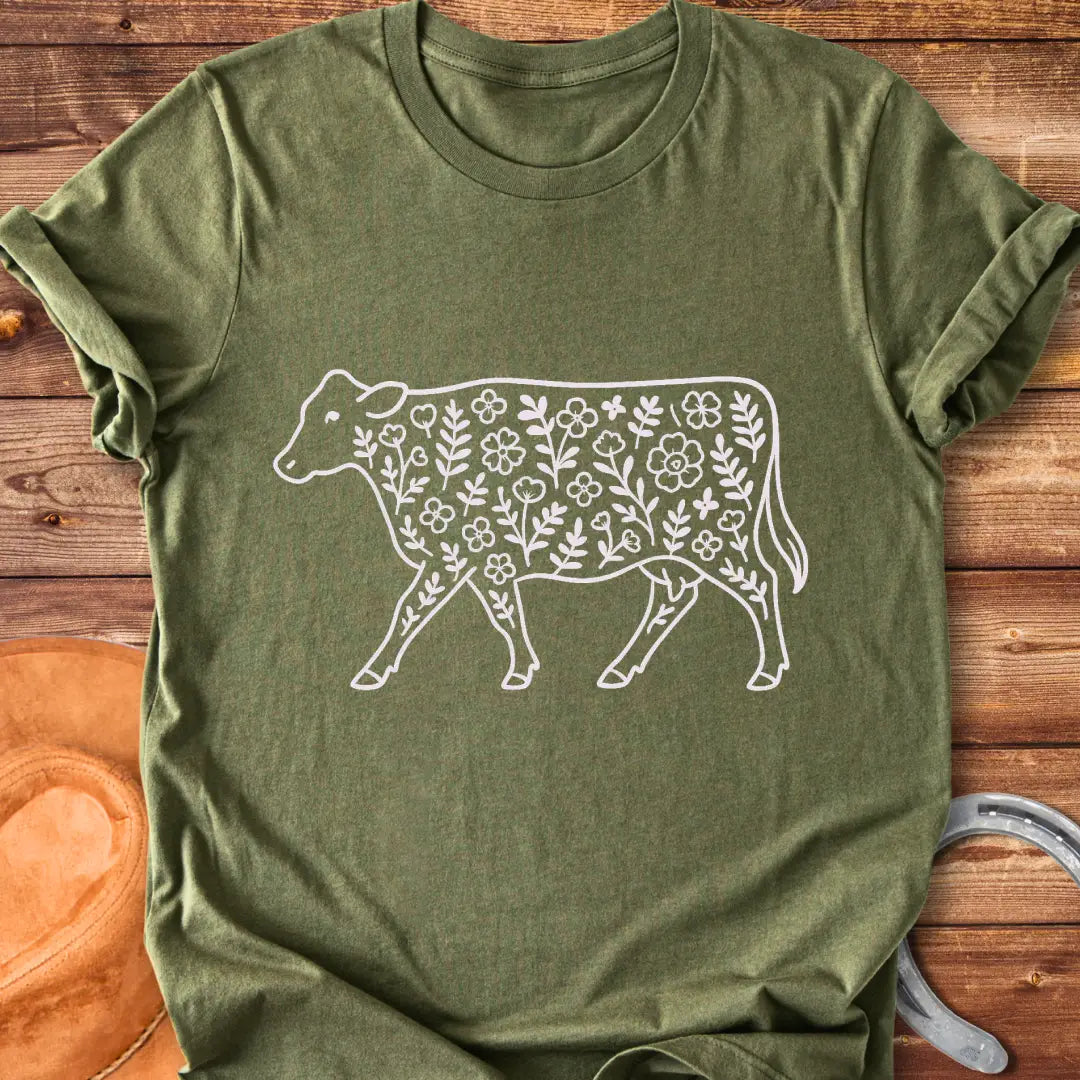 Black and white illustration of a cow with floral design inside.