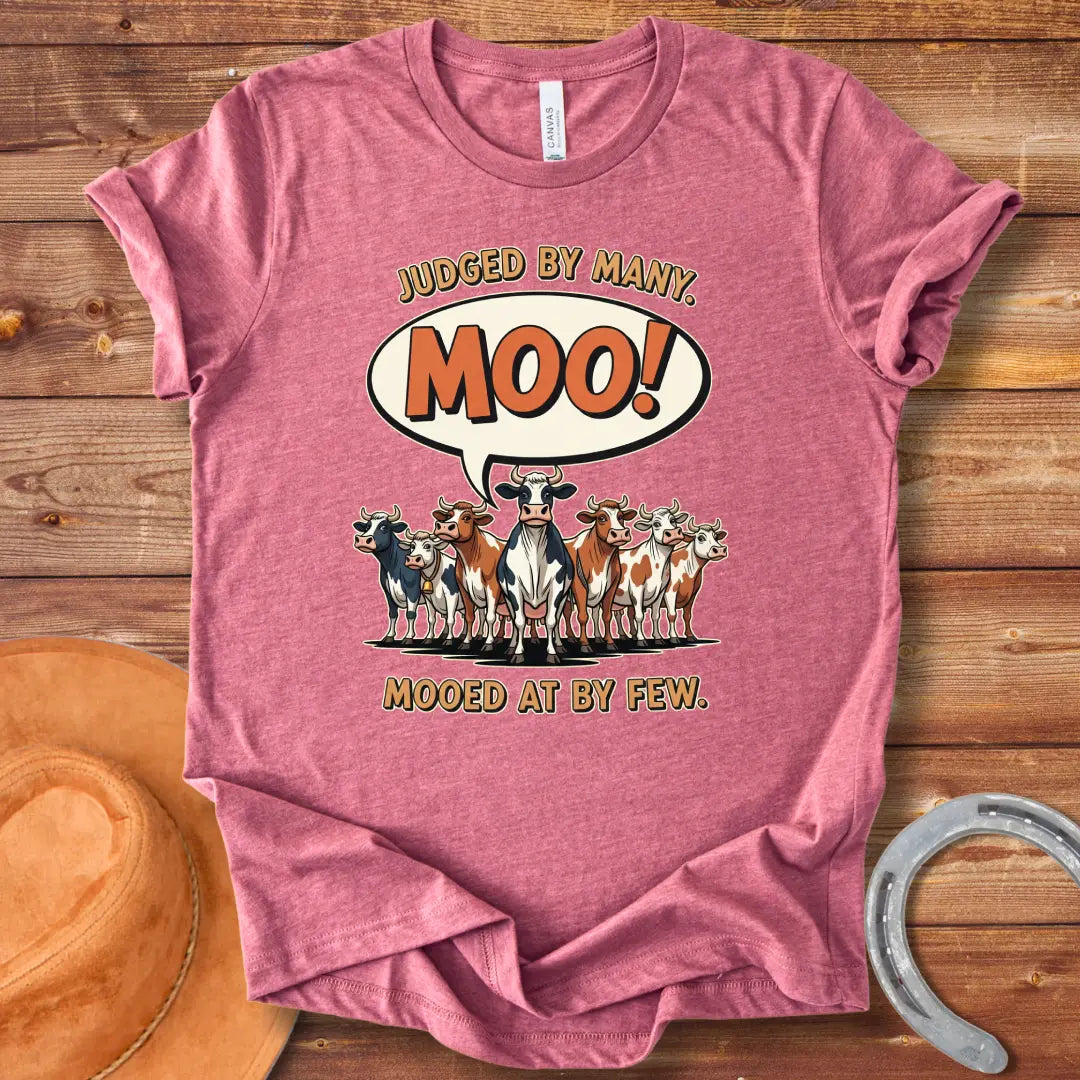 Moo-ed At By Few T-shirt featuring a group of cartoon cows with a speech bubble saying 'Moo!'