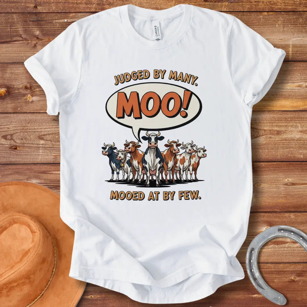 Moo-ed At By Few T-shirt featuring a group of cartoon cows with a speech bubble saying 'Moo!'