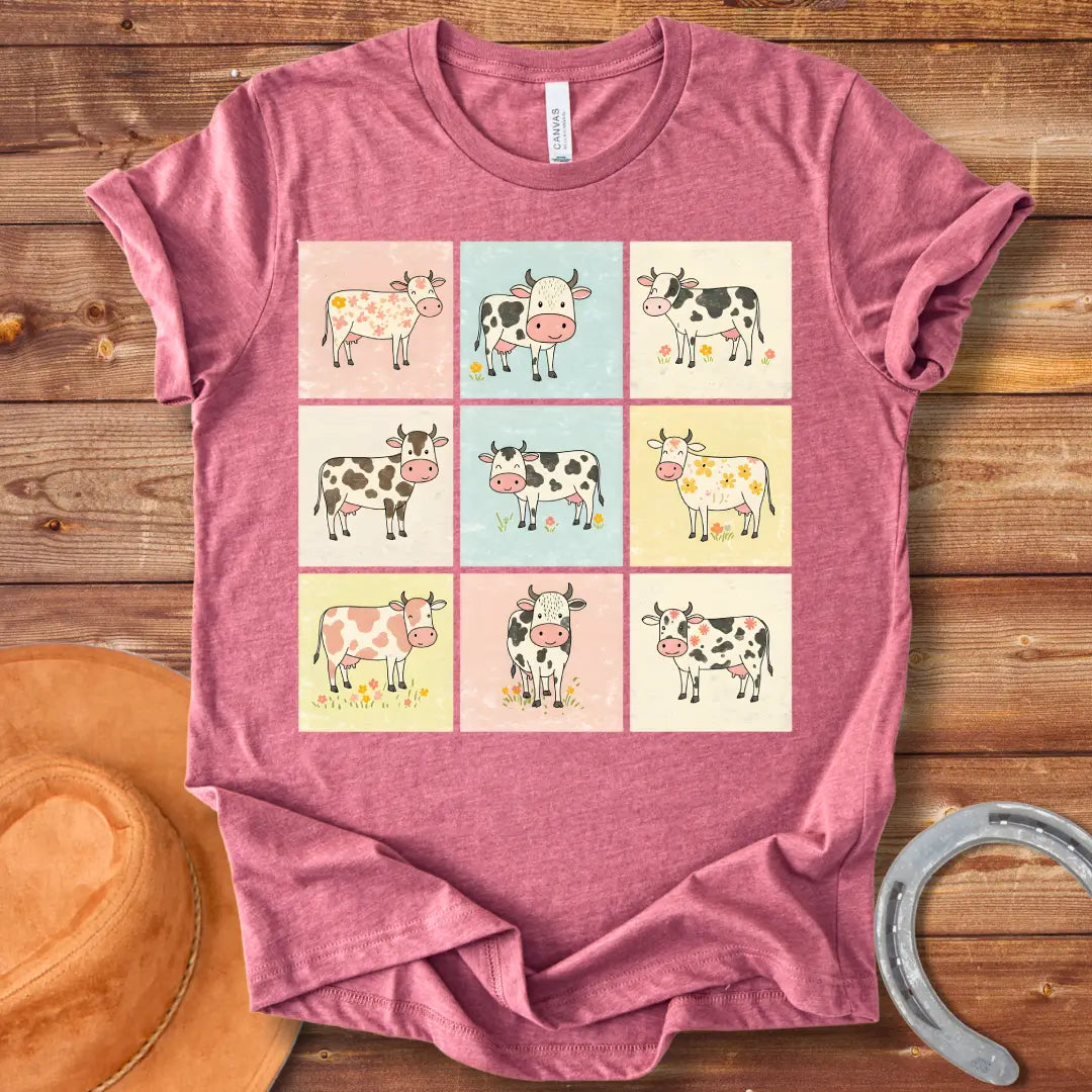 Moo-zaic T-Shirt featuring a mosaic of cute cartoon cows in a variety of colors and patterns, representing the different breeds with floral elements.