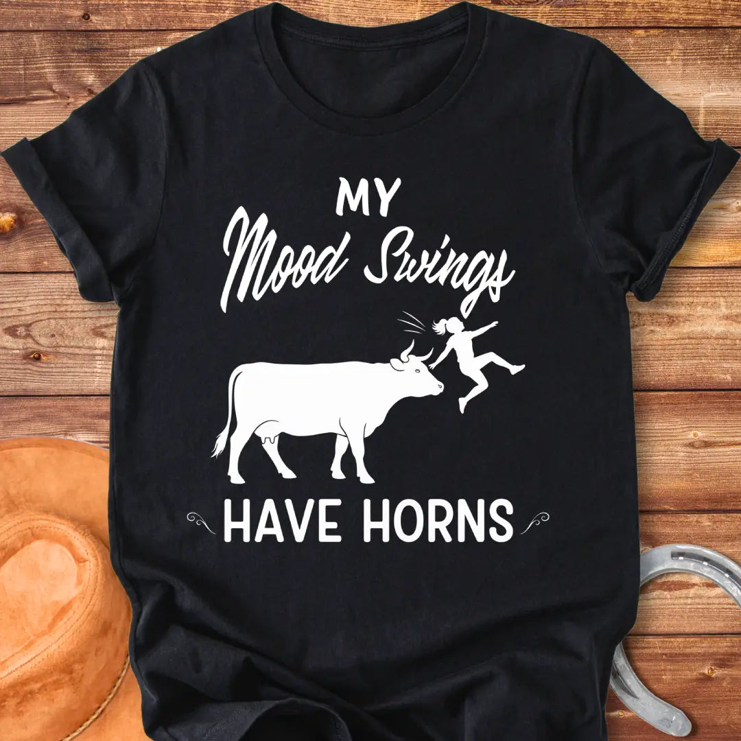 Funny t-shirt design with a cow and the words 'Mood Swings Have Horns'