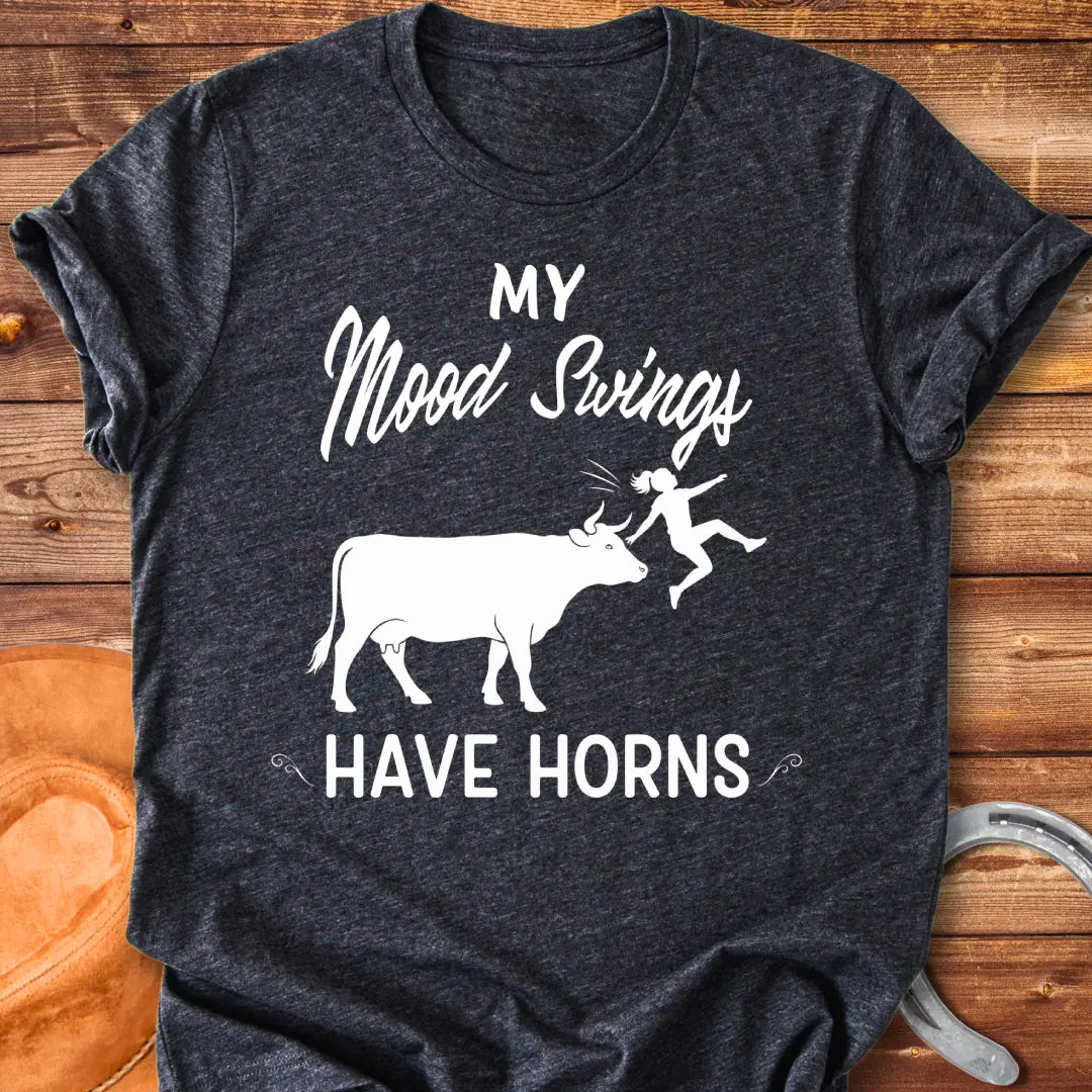 Funny t-shirt design with a cow and the words 'Mood Swings Have Horns'